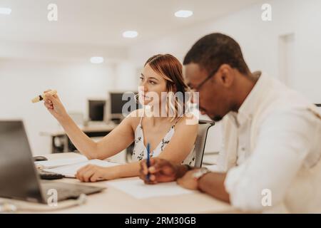 Analyzing business data, diverse team collaborates on strategic planning, innovation, and teamwork. Efficiently working in an office, they aim for gro Stock Photo