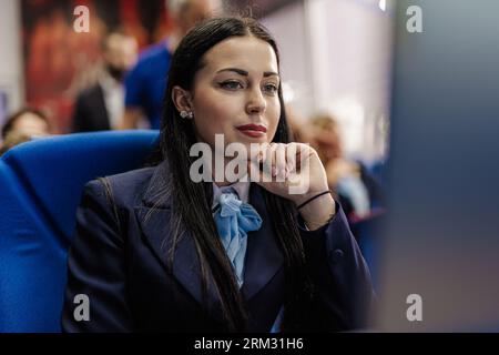 Focused female student reading new lectures on computer at the classroom, self-learning concept Stock Photo