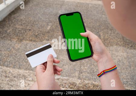 Unrecognizable young woman sitting and browsing smartphone Stock Photo
