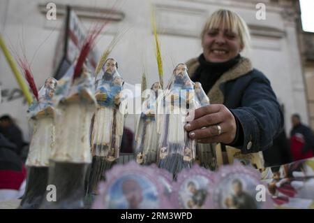 Bildnummer: 60337249  Datum: 07.08.2013  Copyright: imago/Xinhua A woman sells figures of Saint Cayetano in front of the parish that carries his name during the celebration of the Saint Cayetano Day, in the Liniers neighborhood, in Buenos Aires city, capital of Argentina, on Aug. 7, 2013. The holiday of Saint Cayetano, who was beatified on Oct. 8, 1629 by Pope Urban VIII and canonized on April 12, 1671 by Pope Clement X, is celebrated on Aug. 7. (Xinhua/Martin Zabala) ARGENTINA-BUENOS AIRES-SOCIETY-CELEBRATION PUBLICATIONxNOTxINxCHN Kultur Religion Katholische Kirche xns x0x 2013 quer premiumd Stock Photo