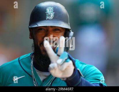 Seattle Mariners' Teoscar Hernandez holds a trident in the dugout