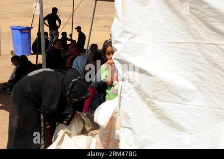 Bildnummer: 60389427  Datum: 24.08.2013  Copyright: imago/Xinhua PESHKHABOUR (IRAQ), Aug. 24, 2013 (Xinhua) -- A Syrian refugee girl hides behind a tent at a makeshift refugee registration center in Sahela area, not far from Peshkhabour crossing bridge over the Tigris River, in northern Iraq, Aug. 24, 2013. Around 45,000 Syrian refugees crossed the border into northern Iraq in the past ten days, marking one of the biggest influxes of refugees since the beginning of the Syrian conflict. In reaction to the huge influx, the UNHCR and other humanitarian agencies set up shelters near the crossing p Stock Photo