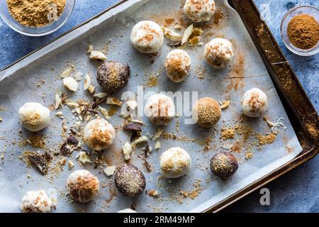 Chocolate dipped truffles on a parchment paper lined cookie sheet. Stock Photo