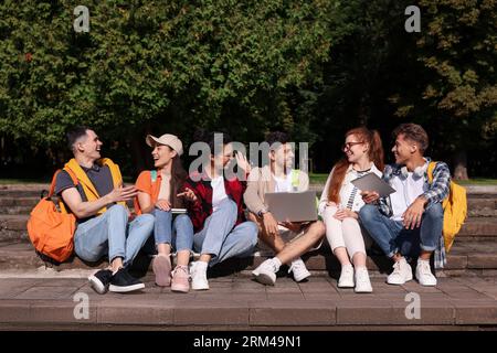Group of happy young students learning together in park Stock Photo