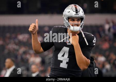 Las Vegas Raiders quarterback Aidan O'Connell (4) gestures as he warms up  before the first half of a preseason NFL football game against the Dallas  Cowboys in Arlington, Texas, Saturday, Aug. 26