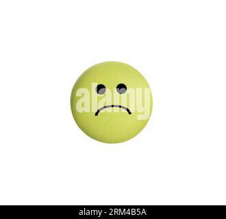 Yellow pill with sad face on white background Stock Photo - Alamy