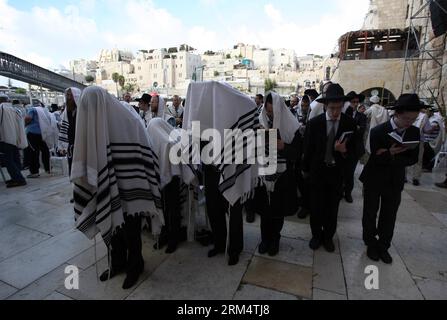 Bildnummer: 60513841  Datum: 22.09.2013  Copyright: imago/Xinhua (130922) -- JERUSALEM, Sept. 22, 2013 (Xinhua) -- Covered in prayer shawls, Jewish men pray during the holiday of Sukkot in front of the Western Wall in Jerusalem s Old City, on Sept. 22, 2013. Thousands of Jewish pilgrims gathered here on Sunday for the Blessing of the Priests, Birkat Kohanim. The Sukkot , Feast of Tabernacles starting from sundown of Wednesday, is a biblical weeklong holiday that recollects the 40 years of travel in the desert after the Exodus from slavery in Egypt. (Xinhua/Muammar Awad) MIDEAST-JERUSALEM-RELIG Stock Photo