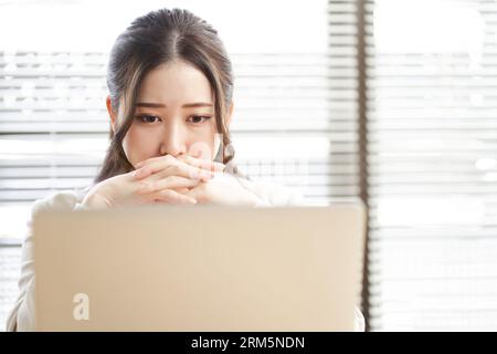 Asian woman thinking in trouble Stock Photo