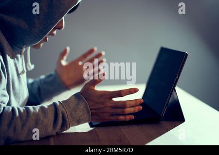 A male hacker who makes mistakes and is in trouble Stock Photo