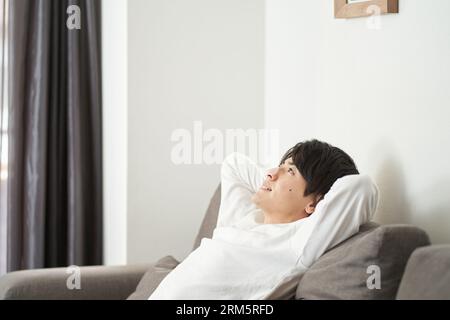Asian man relaxing in the living room Stock Photo