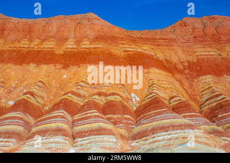 Amazing scenery of Rainbow mountain and blue sky background in sunset. Zhangye Danxia National Geopark, Gansu, China. Copy space for text Stock Photo