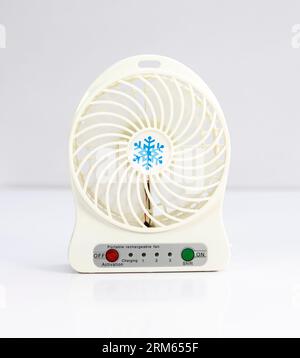 Rechargeable white small fan on white isolated background. Stock Photo