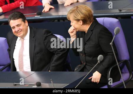 (131217) -- BERLIN, Dec. 17, 2013 (Xinhua) -- German Chancellor Angela Merkel (R) and German Vice-Chancellor and Minister of Economics and Energy Sigmar Gabriel attend the meeting of Bundestag, Germany s lower house of parliament, in Berlin, Germany on Dec. 17, 2013. German new government headed by Chancellor Angela Merkel was sworn into office on Tuesday to rule Europe s biggest economy for the next four years. Cabinet ministers of the new coalition government, are formed by Merkel s Christian Democratic Union (CDU), its Bavarian sister party Chrisitian Social Union (CSU), and the Social Demo Stock Photo
