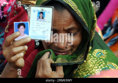 (131224) -- DHAKA, Dec. 24, 2013 (Xinhua) -- A woman mourns when relatives of Rana Plaza victims stage a demonstration in Savar, on the outskirts of Dhaka, Bangladesh, Dec. 24, 2013. Survivors and their loved ones on Tuesday marked the eight-month anniversary of Bangladesh s worst-ever industrial tragedy, while many families express anger and annoyance due to lack of proper aid. Rana Plaza, an eight-story building housing five garment factories, crumbled into a cement grave on April 24 in Savar on the outskirts of capital Dhaka, killing more than 1,130 people, mostly workers. (Xinhua/Shariful Stock Photo