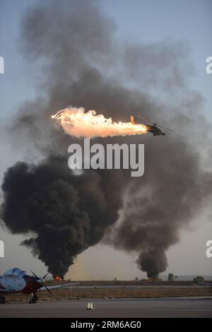 (131227) -- BE ER SHEVA (ISRAEL), Dec. 27, 2013 (Xinhua) -- An Apache helicopter gunship releases decoy flares during an air show highlighting the Israeli Air Force s 167th class pilot graduation at the Hatzerim Air Base in Be er Sheva, southern Israel, on Dec. 26, 2013. The Israeli Air Force welcomed into its ranks a new batch of pilots, with the country s political and military leaderships on hand to congratulate here on Thursday. (Xinhua/IDF/Judah Ari Gross) ISRAEL-BE ER SHEVA-HATZERIM AIR BASE-IAF-PILOT-GRADUATION PUBLICATIONxNOTxINxCHN   Be he Sheva Israel DEC 27 2013 XINHUA to Apache Hel Stock Photo
