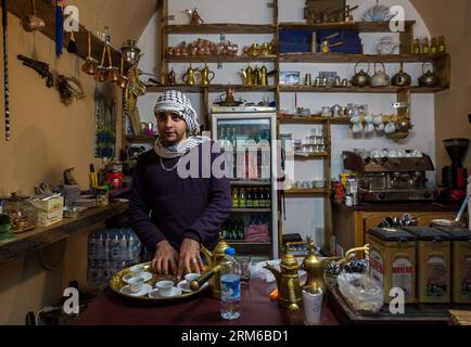 (131231) -- ACRE, Dec. 31, 2013 (Xinhua) -- An Arab man sells drinks at a coffee shop along the Turkish Bazaar in the Old City of Acre, northern Israel, on Dec. 27, 2013. The Old City of Acre in Acre in Israel was inscribed on the UNESCO World Heritage List in 2001. With a history of more than 5,000 years recorded in documents, Acre is a walled port-city with continuous settlement from the Phoenician period. The present city is characteristic of a fortified town of the Ottoman dating from 18th and 19th centuries, with typical urban components such as the citadel, mosques, khans and baths. The Stock Photo