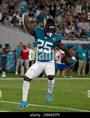 Jacksonville Jaguars running back D'Ernest Johnson (25) is tackled by Detroit  Lions linebacker Julian Okwara (99) defensive tackle Cory Durden (90) and  linebacker Jalen Reeves-Maybin (42) against the Detroit Lions during an