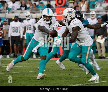 Jacksonville, United States. 26th Aug, 2023. Quarterback Tua Tagovailoa hands off to Running Back Myles Gaskin in the first quarter as the Dolphins compete against the Jaguars in an NFL preseason game at the EverBank Stadium in Jacksonville, Florida on Saturday, August 26, 2023. The Jaguars defeated Miami by a score of 31-18. Photo by Joe Marino/UPI. Credit: UPI/Alamy Live News Stock Photo