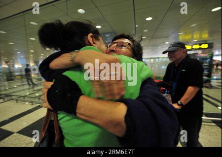 (140107) -- SINGAPORE, Jan. 7, 2014 (Xinhua) -- A passenger (C) on board the Airbus A380 aircraft, which made an emergency landing at Azerbaijan s capital Baku, embraces her relative in Singapore s Changi International airport, Jan. 7, 2013. Singapore Airlines s replacement aircraft on Tuesday picked up passengers and cabin crew stranded in Azerbaijan s Baku and return to Singapore after a flight operated by the company made an emergency landing at Azerbaijan s capital city on Monday.(Xinhua/Then Chih Wey) (srb) SINGAPORE-STRANDED PASSENGERS-RETURN PUBLICATIONxNOTxINxCHN   Singapore Jan 7 2014 Stock Photo