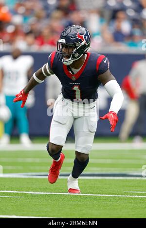 August 19, 2023: Miami Dolphins running back Salvon Ahmed (26) carries the  ball as Houston Texans safety Jimmie Ward (1) looks on after missing a  tackle during an NFL preseason game between