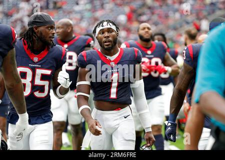 August 19, 2023: Miami Dolphins running back Salvon Ahmed (26) carries the  ball as Houston Texans safety Jimmie Ward (1) looks on after missing a  tackle during an NFL preseason game between