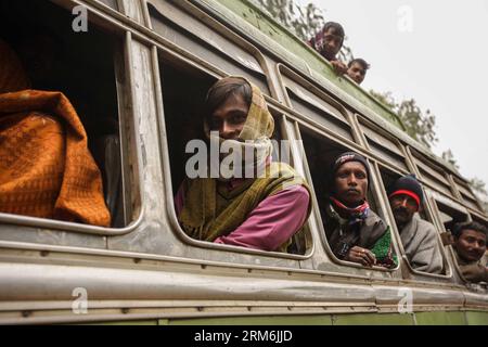 (140116) -- WEST BENGAL, (Xinhua) -- People take bus to the Joydev Kenduli Mela in the village of Kenduli, Joydev in West Bengal State of India, Jan. 15, 2014. The Joydev Kenduli Mela, a three-day grand fair to commemorate India s famous ancient poet Joyadeva who composed the Gita Govinda, was held on Wednesday. Tens of thousands of tourists were attracted to come not only to hear the Bauls who sing the hymns composed by Joyadeva, but also to enjoy the flavour of a typical Indian countryside market, such as snake charmers, street food and so on. (Xinhua/Zheng Huansong) INDIA-WEST BENGAL-JOYDEV Stock Photo