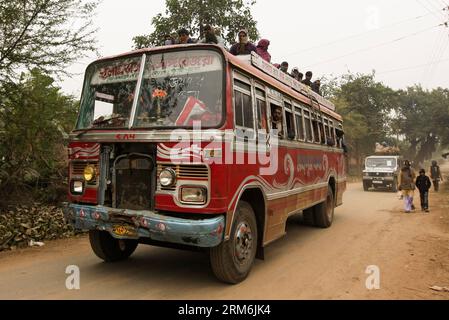 (140116) -- WEST BENGAL, (Xinhua) -- People take bus to the Joydev Kenduli Mela in the village of Kenduli, Joydev in West Bengal State of India, Jan. 15, 2014. The Joydev Kenduli Mela, a three-day grand fair to commemorate India s famous ancient poet Joyadeva who composed the Gita Govinda, was held on Wednesday. Tens of thousands of tourists were attracted to come not only to hear the Bauls who sing the hymns composed by Joyadeva, but also to enjoy the flavour of a typical Indian countryside market, such as snake charmers, street food and so on. (Xinhua/Zheng Huansong) INDIA-WEST BENGAL-JOYDEV Stock Photo