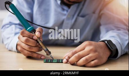 Hands, soldering and circuit board, computer hardware fix with technician person, maintenance and electronics upgrade. Tools, motherboard and CPU Stock Photo