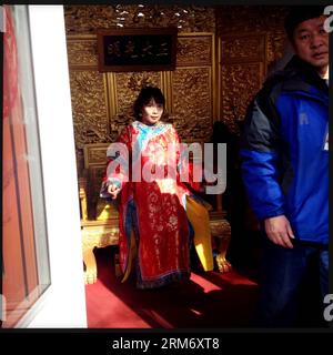 (140203) -- BEIJING, Feb. 2, 2014 (Xinhua) -- In this photo taken with a smartphone on Feb. 2, 2014, a tourist attired in a traditional Chinese costume (L) poses for photos at the Yuanmingyuan Temple Fair in Beijing, capital of China. In Beijing, temple fairs have been a typical repertoire during the Spring Festival, which fell on Jan. 31 this year. People entertain themselves at temple fairs with various food and snacks as well as folk activities. (Xinhua/Shen Bohan) (lmm) CHINA-BEIJING-SPRING FESTIVAL-TEMPLE FAIR-SMARTPHONE (CN) PUBLICATIONxNOTxINxCHN   Beijing Feb 2 2014 XINHUA in This Phot Stock Photo