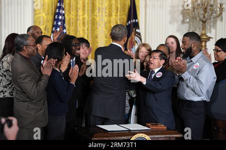 (140212) -- WASHINGTON, Feb. 12, 2014 (Xinhua) -- U.S. President Barack Obama is greeted by workers after signing an executive order to raise the minimum wage for federal contract workers in the East Room of the White House in Washington D.C., the United States, Feb. 12, 2014. The move, first announced during the State of the Union address, will raise the minimum wage for federal contractors to 10.10 dollars per hour from the current rate of 7.25 dollars. (Xinhua/Yin Bogu) U.S.-WASHINGTON-OBAMA-MINIMUM WAGE-ORDER PUBLICATIONxNOTxINxCHN   Washington Feb 12 2014 XINHUA U S President Barack Obama Stock Photo