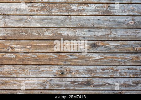 Background from a worn brown plank wall with flaking paint Stock Photo