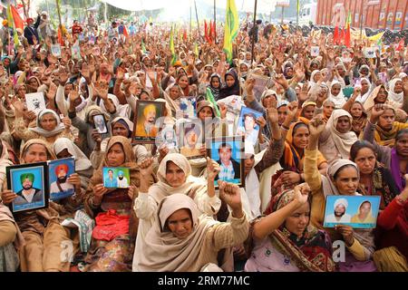 (140217) -- PUNJAB, Feb. 17, 2014 (Xinhua) -- Farmers hold photographs of their relatives who committed suicide, during a protest opposite mini secretariat building in Bathinda, India, Feb. 17, 2014. The protesters demand for compensation to farmers and farm laborers who had committed suicide due to debt. They also want the state government to write off the farmers debts and allot plots to homeless farm laborers. (Xinhua/Stringer) INDIA-PUNJAB-FARMER PROTEST PUBLICATIONxNOTxINxCHN   Punjab Feb 17 2014 XINHUA Farmers Hold Photographs of their Relatives Who Committed Suicide during a Protest opp Stock Photo