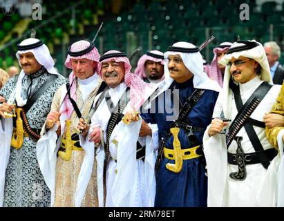 RIYADH , Feb. 18, 2014 -- Saudi Arabia s second deputy Prime Minister Muqrin bin Abdulaziz (3rd L) and visiting Britain s Prince Charles (2nd L) perform the traditional Saudi dance known as Arda during the Janadriya culture festival in Riyadh, Feb. 18, 2014. (Xinhua) (srb) SAUDI ARABIA-CULTURE-FESTIVAL PUBLICATIONxNOTxINxCHN   Riyadh Feb 18 2014 Saudi Arabia S Second Deputy Prime Ministers Muqrin am Abdul Aziz 3rd l and Visiting Britain S Prince Charles 2nd l perform The Traditional Saudi Dance known As Arda during The  Culture Festival in Riyadh Feb 18 2014 XINHUA SRB Saudi Arabia Culture Fes Stock Photo