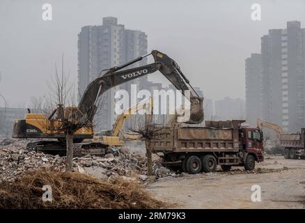 (140220) -- BEIJING, Feb. 20, 2014 (Xinhua) -- An excavator works on ruins of illegal houses demolished in Zhenggezhuang Village, Beiqijia Township of Changping District on the outskirt of Beijing, China, Feb. 20, 2014. Those illegal houses cover an area of 108.55 mu (about 7.24 hectares) , which will be used for tree planting after complete of demolition. (Xinhua/Luo Xiaoguang) (hdt) CHINA-BEIJING-CHANGPING-ILLEGAL HOUSES-DEMOLITION (CN) PUBLICATIONxNOTxINxCHN   Beijing Feb 20 2014 XINHUA to excavator Works ON Ruins of illegal Houses Demolished in  Village  Township of Chang Ping District ON Stock Photo