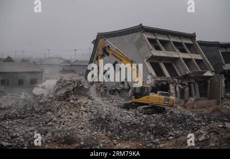 (140220) -- BEIJING, Feb. 20, 2014 (Xinhua) -- An excavator demolishes illegal houses in Zhenggezhuang Village, Beiqijia Township of Changping District on the outskirt of Beijing, China, Feb. 20, 2014. Those illegal houses cover an area of 108.55 mu (about 7.24 hectares) , which will be used for tree planting after complete of demolition. (Xinhua/Luo Xiaoguang) (hdt) CHINA-BEIJING-CHANGPING-ILLEGAL HOUSES-DEMOLITION (CN) PUBLICATIONxNOTxINxCHN   Beijing Feb 20 2014 XINHUA to excavator demolishes illegal Houses in  Village  Township of Chang Ping District ON The outskirts of Beijing China Feb 2 Stock Photo