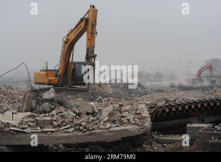 (140220) -- BEIJING, Feb. 20, 2014 (Xinhua) -- An excavator demolishes illegal houses in Zhenggezhuang Village, Beiqijia Township of Changping District on the outskirt of Beijing, China, Feb. 20, 2014. Those illegal houses cover an area of 108.55 mu (about 7.24 hectares) , which will be used for tree planting after complete of demolition. (Xinhua/Luo Xiaoguang) (hdt) CHINA-BEIJING-CHANGPING-ILLEGAL HOUSES-DEMOLITION (CN) PUBLICATIONxNOTxINxCHN   Beijing Feb 20 2014 XINHUA to excavator demolishes illegal Houses in  Village  Township of Chang Ping District ON The outskirts of Beijing China Feb 2 Stock Photo