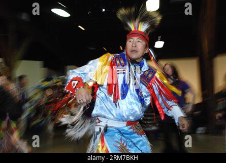 An aboriginal man dances at the Native Indian Pow Wow as part of the annual Talking Stick Aboriginal Arts Festival in Vancouver, Canada, on Feb. 23, 2014. The Talking Stick Festival is a two-week celebration, aimed at preserving and promoting the language, culture and art forms of the First Nations people by developing and presenting aboriginal traditions of music, dance and storytelling in a contemporary and entertaining way. (Xinhua/Sergei Bachlakov) CANADA-VANCOUVER-NATIVE-TRADITIONAL EVENT PUBLICATIONxNOTxINxCHN   to Aboriginal Man Dances AT The NATIVE Indian Pow Wow As Part of The Annual Stock Photo