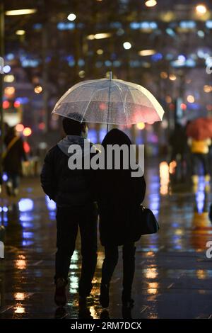 (140226) -- BEIJING, Feb. 26, 2014 (Xinhua) -- A couple walk with an umbrella in the rain in Xidan, a commercial area in Beijing, capital of China, Feb. 26, 2014. Beijing saw its first rain this spring on Wednesday evening. The precipitation would be conducive to the city s air quality, which had been marred by a lingering smog. (Xinhua/Li Xin) (lmm) CHINA-BEIJING-RAIN (CN) PUBLICATIONxNOTxINxCHN   Beijing Feb 26 2014 XINHUA a COUPLE Walk With to Umbrella in The Rain in Xidan a Commercial Area in Beijing Capital of China Feb 26 2014 Beijing SAW its First Rain This Spring ON Wednesday evening T Stock Photo