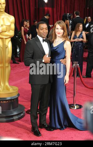 Chiwetel Ejiofor (L), best actor nominee for his role in the film 12 Years a Slave , and his girlfriend Sari Mercer arrive arrives for the red carpet of the 86th Academy Awards at the Dolby Theater in Los Angeles, the United States, March 2, 2014. (Xinhua/Yang Lei)(ctt) US-LOS ANGELES-OSCARS-RED CARPET ARRIVALS PUBLICATIONxNOTxINxCHN   Chiwetel Ejiofor l Best Actor Nominee for His Role in The Film 12 Years a Slave and His Girlfriend Sari Mercer Arrive arrives for The Red Carpet of The 86th Academy Awards AT The Dolby Theatre in Los Angeles The United States March 2 2014 XINHUA Yang Lei CTT U.S Stock Photo