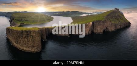 Sunset over Cliffs of Traelanipa on Vagar island, Faroe Islands, mountain ocean landscape Stock Photo