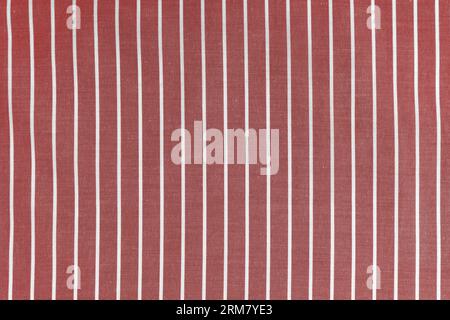 Striped red white fabric texture background wtih copy space. Shirt fabric, tablecloth textile, garment cloth, upholstery with classic pattern with lin Stock Photo