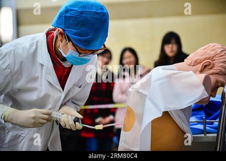 A medical intern practises bone marrow aspiration in a clinical skill competition in Tianjin Medical University in Tianjin, north China, March 21, 2014. A total of 24 medical students of Tianjin Medical University took part in the competition. (Xinhua/You Sixing) (lfj) CHINA-TIANJIN-CLINICAL COMPETITION (CN) PUBLICATIONxNOTxINxCHN   a Medical INTERN practices Bone Marrow Aspiration in a Clinical Skill Competition in Tianjin Medical University in Tianjin North China March 21 2014 a total of 24 Medical Students of Tianjin Medical University took Part in The Competition XINHUA You   China Tianjin Stock Photo