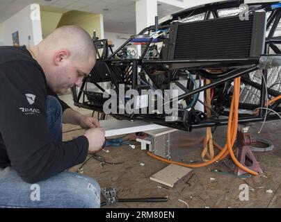 A worker of the Rimac Automobili electric vehicles company assembles a Concept One supercar at Rimac Automobili headquarters in Sveta Nedelja near Zagreb, Croatia, March 21, 2014. Rimac Automobili is a Croatian company that develops and produces high-performance electric vehicles, drivetrain and battery systems. Rimac Automobili s first model, the Concept One, is known as the world s fastest production electric vehicle. Recently, Rimac started cooperation with several Chinese companies. (Xinhua/Miso Lisanin)(bxq) CROATIA-ZAGREB-RIMAC ELECTRIC VEHICLES COMPANY PUBLICATIONxNOTxINxCHN   a Worker Stock Photo