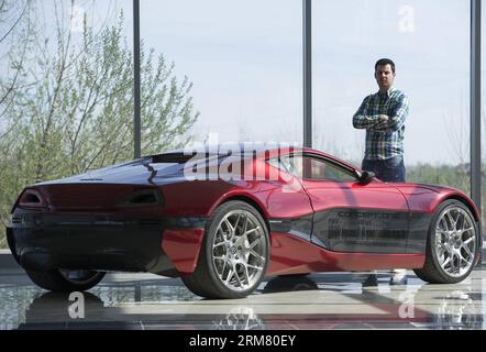 Owner of the Rimac Automobili electric vehicles company Mate Rimac poses next to his Concept One electric supercar during an interview at Rimac Automobili headquarters in Sveta Nedelja near Zagreb, Croatia, March 21, 2014. Rimac Automobili is a Croatian company that develops and produces high-performance electric vehicles, drivetrain and battery systems. Rimac Automobili s first model, the Concept One, is known as the world s fastest production electric vehicle. Recently, Rimac started cooperation with several Chinese companies. (Xinhua/Miso Lisanin)(bxq) CROATIA-ZAGREB-RIMAC ELECTRIC VEHICLES Stock Photo