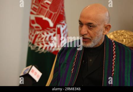 (140326) -- KABUL, March 26, 2014 (Xinhua) -- Afghan President Hamid Karzai speaks during an interview with Xinhua News Agency at the presidential palace in Kabul, Afghanistan on March 26, 2014. Afghan President Hamid Karzai on Wednesday utterly rejected the rumors and reports suggesting he would sign the controversial Bilateral Security Agreement (BSA) with Washington before April 5 presidential elections to allow limited number of U.S. forces remain in Afghanistan after 2014 pullout of NATO-led troops from the militancy-plagued country. (Xinhua/Ahmad Massoud) (lmz) AFGHANISTAN-KABUL-PRESIDEN Stock Photo