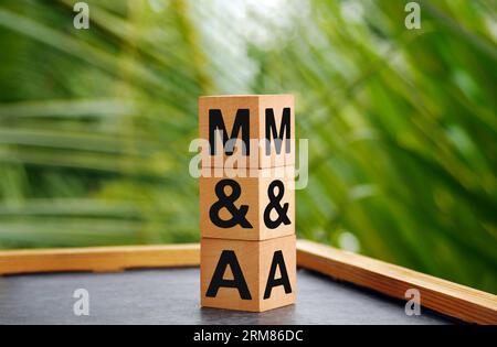 The letters M and S written on wood cubes. bokeh nature background. M and A - short for Mergers and Acquisitions, business concept. Stock Photo