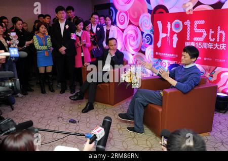 (140331) -- HANGZHOU, Nov. 16, 2013 (Xinhua) -- In this file photo taken on Nov. 16, 2013, Alibaba s CEO Jack Ma Yun (1st R) and Intime Retail Group Co. chairman Shen Guojun (2nd R) attend an event celebrating the 15th anniversary of Intime s department stores in Hangzhou, capital of east China s Zhejiang Province. Chinese e-commerce giant Alibaba Group announced on Monday that it will pay 5.3 billion Hong Kong dollars (692 million U.S. dollars) to acquire shares of Hong Kong-listed department store operator Intime (Yintai) Retail Group Co. Under the two companies agreement, Alibaba will acqui Stock Photo