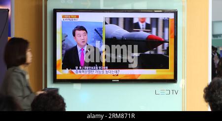 (140331) -- SEOUL, March 31, 2014 (Xinhua) -- People watch news report about exchange of artillery shells between the Democratic People s Republic of Korea (DPRK) and the Republic of Korea (ROK) in Seoul, capital of ROK, on March 31, 2013. The ROK Defense Ministry said on Monday that its military fired back after DPRK artillery shells fell south of the western sea border. On Monday, the DPRK began a live-fire drill near the disputed western maritime border with the ROK. The UN Security Council issued a statement on Friday, condemning the DPRK s recent ballistic missile launches. (Xinhua/Yao Qi Stock Photo