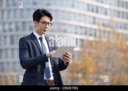 Confident businessman using digital tablet Stock Photo