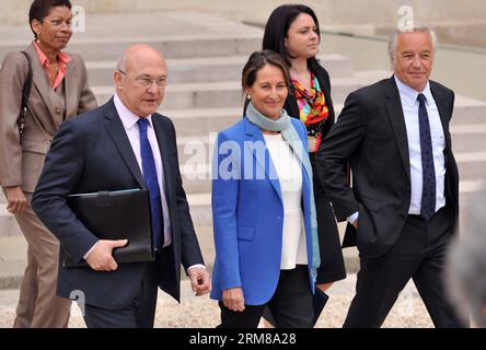 PARIS, April 4, 2014 - (From left to right) French Overseas Territories Minister George Pau-Langevin, Finance Minister Michel Sapin, Environment, Energy Minister Segolene Royal, Housing Minister Sylvia Pinel and Labour Minister Francois Rebsamen walk out of the Elysee presidential palace after the first cabinet meeting in Paris, France, April 4, 2014. (Xinhua/Chen Xiaowei) (zhf) FRANCE-PARIS-NEW CABINET-FIRST MEETING PUBLICATIONxNOTxINxCHN   Paris April 4 2014 from left to Right French Overseas Territories Ministers George Pau Langevin Finance Ministers Michel Sapin Environment Energy Minister Stock Photo